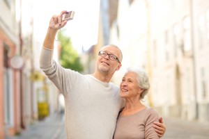 senior couple photographing on city street